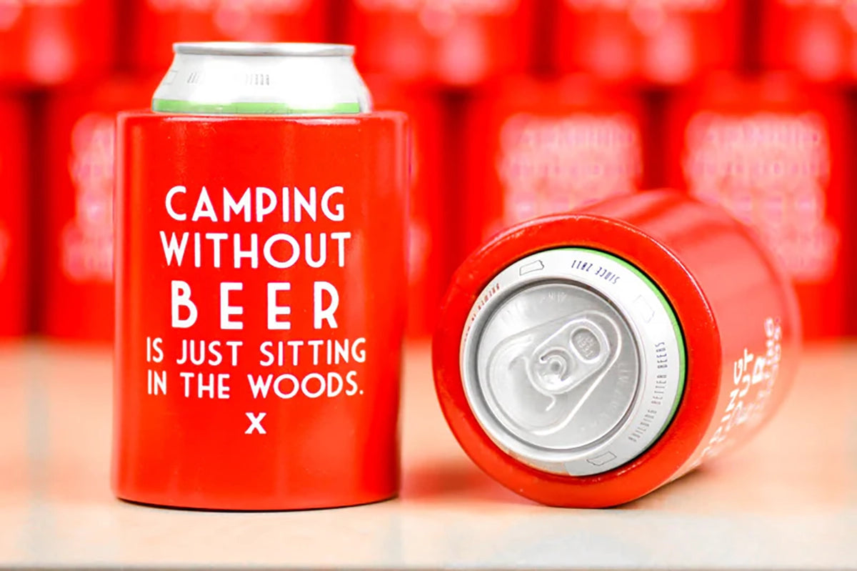 Red foam can cooler with "Camping without Beer is just sitting in the woods" printed  in white