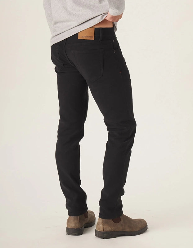 Model Wearing The Normal Brand Comfort Terry Pants in Black, rear view