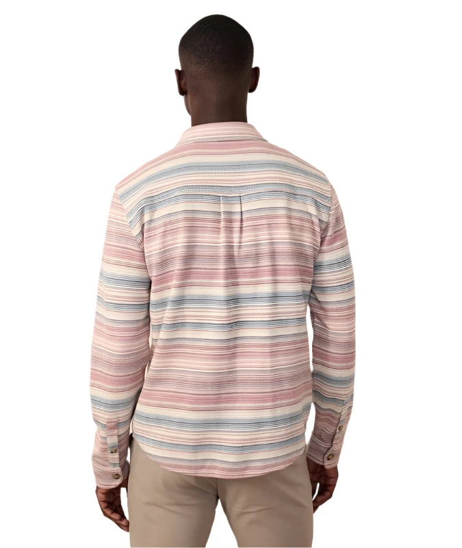 Model wearing Marine Layer Pacifica Stretch Twill Shirt in warm Baja stripe, rear  view