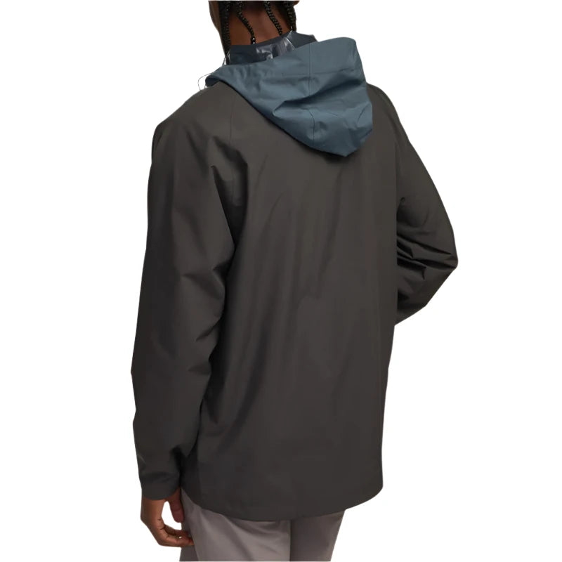 Model Wearing Howler Bros. Storm Splitter Rain Shell jacket, in antique Black and Slate color, rear  view