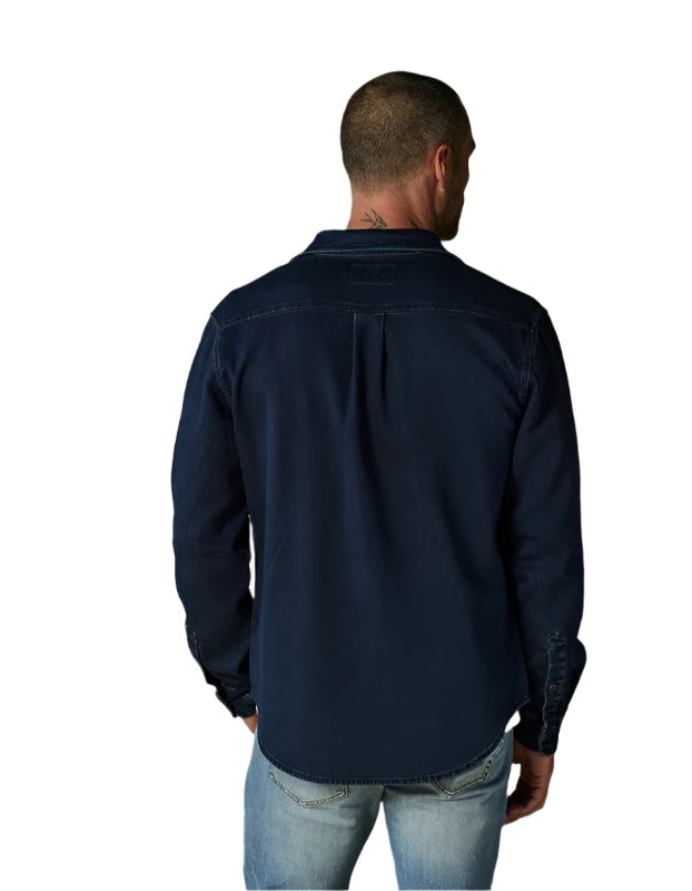 Model wearing The Normal Brand Big Jake shirt in dark indigo , rear  view