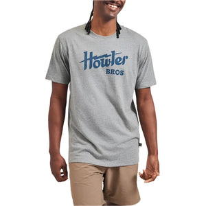 Model wearing  Howler Bros. Electric T-shirt in Heather Grey with Blue electric design, front view