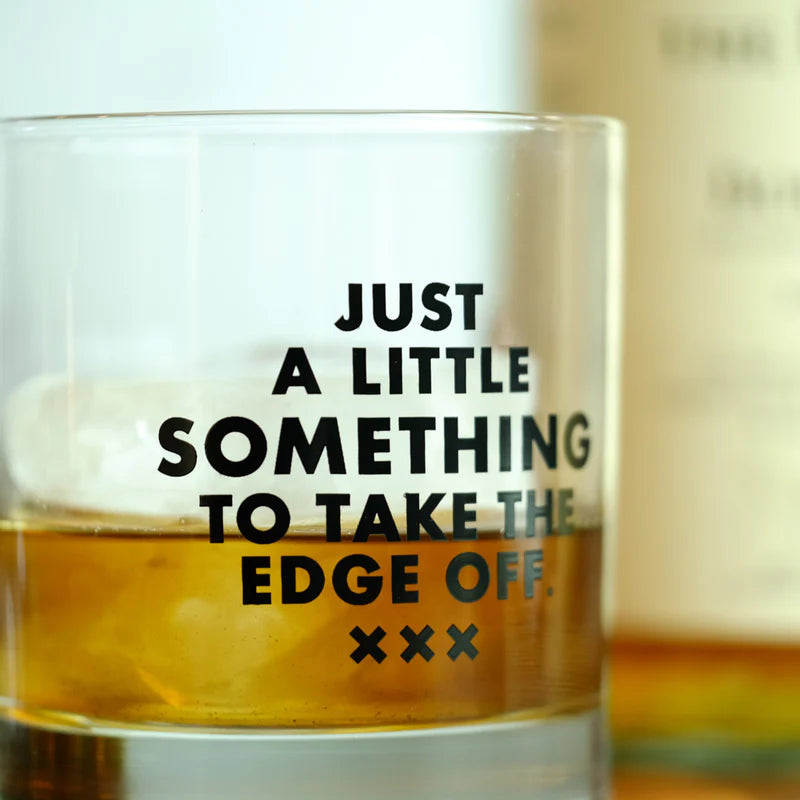 Whiskey glass with witty saying screen printed up close